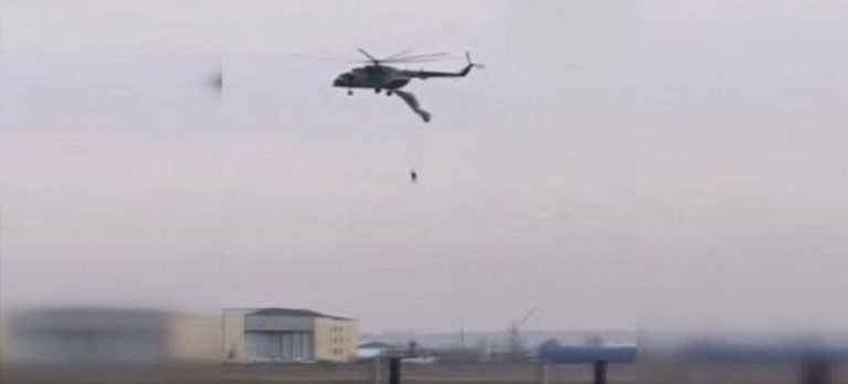 Askeri helikoptere takılan paraşütçü havada asılı kaldı
